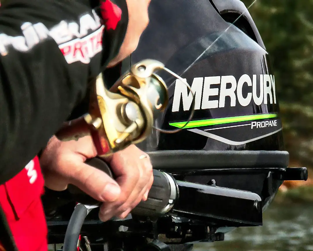 Fishing line on a spinning reel set against a Mercury outboard motor
